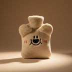 Brown bear-shaped hot water bottle with measurements on a white background